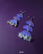 Parvaaz purple drop earrings in a teardrop shape, hand-painted in rich purple with tiny golden dot accents, highlighting the artisanal detail and showcasing a blend of regal charm and minimal elegance — Muselot.
