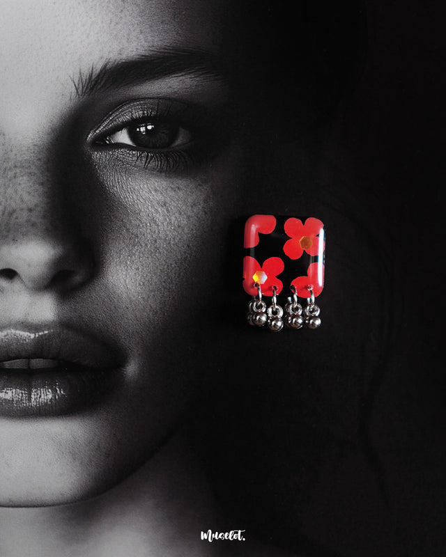 The model is wearing a beautiful piece, the Raktphool floral stud earring, elegantly designed with a delicate floral motif, highlighting its charm — Muselot.