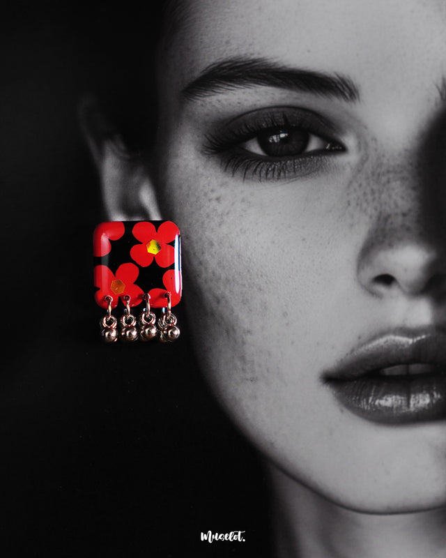 The model is showcasing the exquisite Raktphool floral stud earring, featuring a finely crafted floral design that enhances its elegance — Muselot.