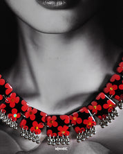 The model is wearing the stunning Raktphool floral jewelry set, featuring a delicate floral necklace that adds a touch of grace and charm to the ensemble — Muselot.