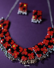 The Raktphool floral jewelry set, showcasing a pair of beautifully designed earrings with intricate floral patterns. The delicate craftsmanship and elegance of the earrings make them a perfect accessory for any occasion — Muselot.