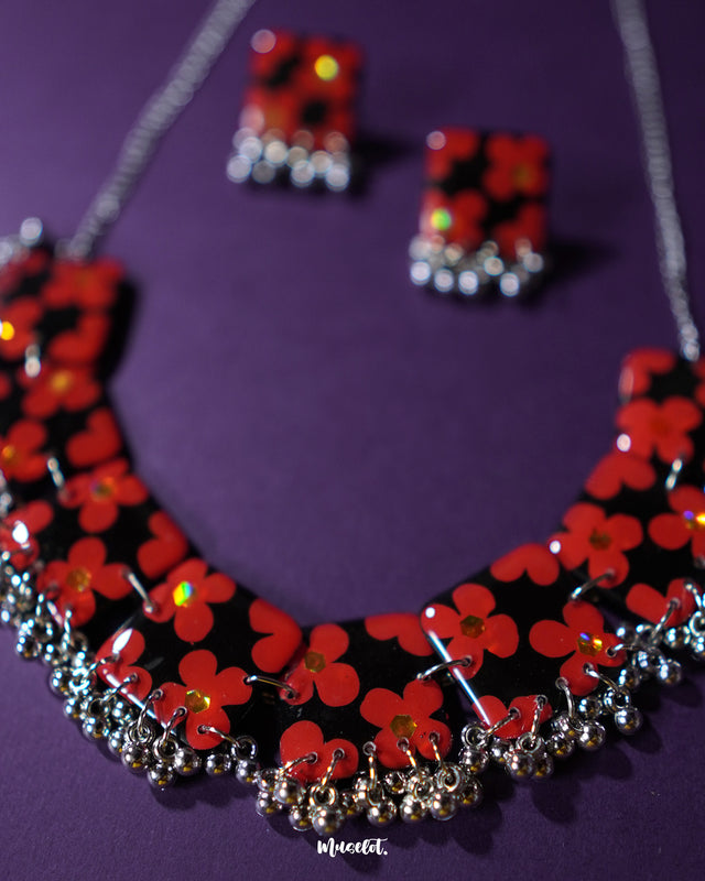 The Raktphool floral jewelry set, showcasing a pair of beautifully designed earrings with intricate floral patterns. The delicate craftsmanship and elegance of the earrings make them a perfect accessory for any occasion — Muselot.