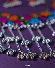 Close-up view of the gunghroo chain from the Rangbaagh black floral necklace set, showcasing its traditional metallic beads that add rhythmic charm and ethnic flair to the handcrafted design — Muselot