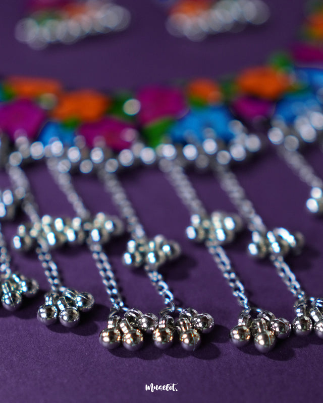 Close-up view of the gunghroo chain from the Rangbaagh black floral necklace set, showcasing its traditional metallic beads that add rhythmic charm and ethnic flair to the handcrafted design — Muselot