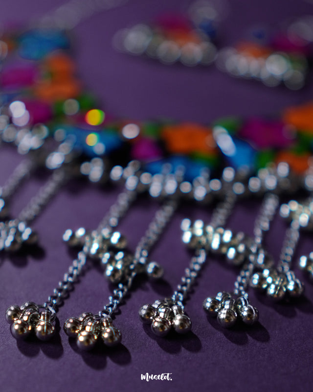 A zoomed-in shot of the Rangbaagh black floral necklace set focusing on the gungroo chain, capturing its intricate craftsmanship, traditional charm, and delicate shimmer that adds movement and elegance — Muselot.