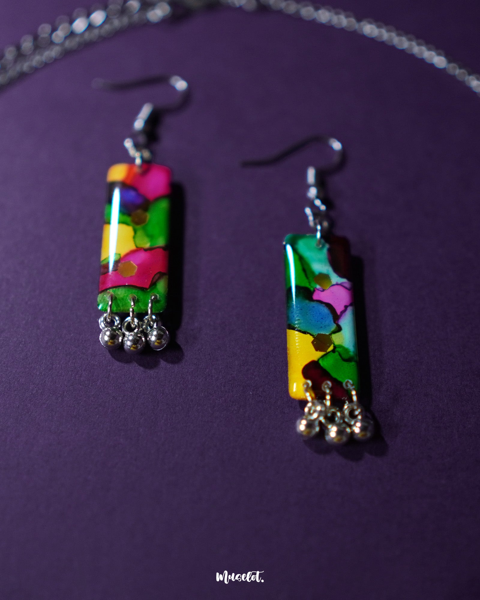 Rangbaari colorful earrings featuring vibrant multicolor abstract rectangular charms with silver bead accents, elegantly showcased to highlight their intricate design and lively hues – Muselot.