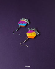 A pair of Rangbahaar colorful hook earrings placed on a neutral background, highlighting the intricate embroidery, mirror accents, and beaded fringes that celebrate vibrant Indian craftsmanship — Muselot.