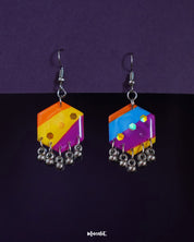 Rangbahaar hook earrings featuring asymmetrical hexagonal drops in vibrant orange, yellow, pink, and blue segments, adorned with glossy sequins and metallic jhumki-style danglers — Muselot.