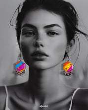 A model wears the Rangbahaar hook earrings, showcasing the vivid blend of orange, yellow, pink, and blue tones with shimmering sequins and playful metallic danglers, adding a bold and festive charm to her look — Muselot.