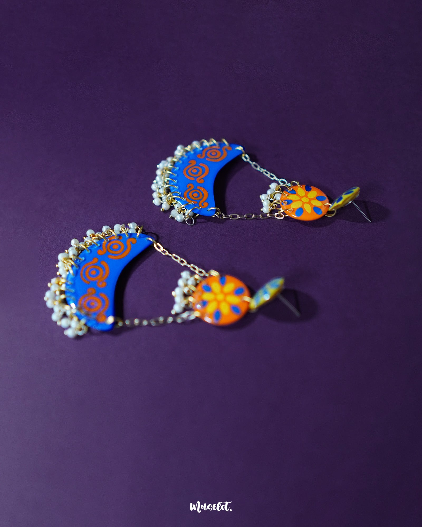 Ranglahar blue chandbaali earrings with ornate silver-toned craftsmanship and delicate pearl accents, exuding timeless charm in a serene layout — Muselot.