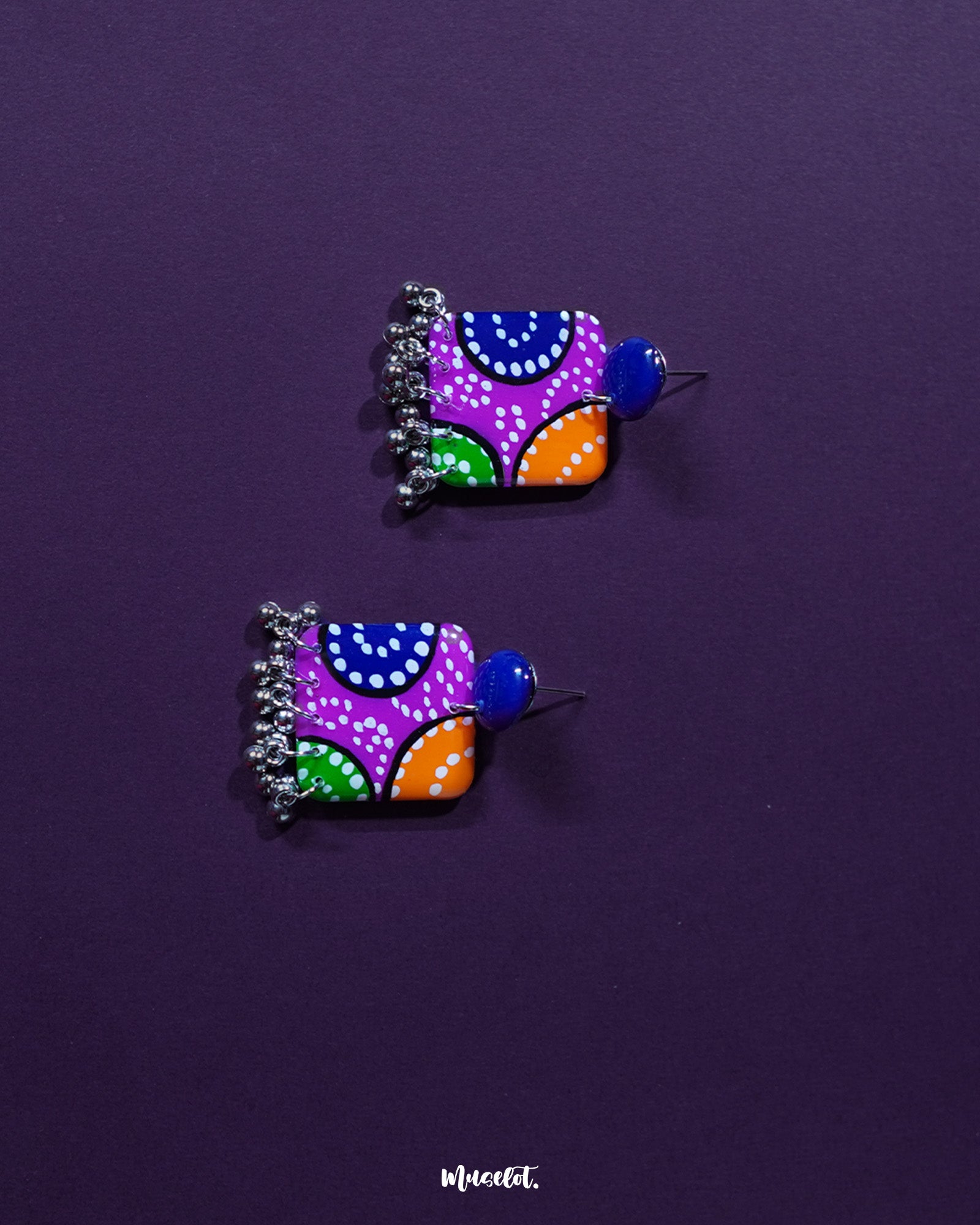 Rangras stud earrings shown in a detailed close-up, emphasizing the vivid folk-inspired patterns and rich color palette that celebrates traditional craftsmanship — Muselot