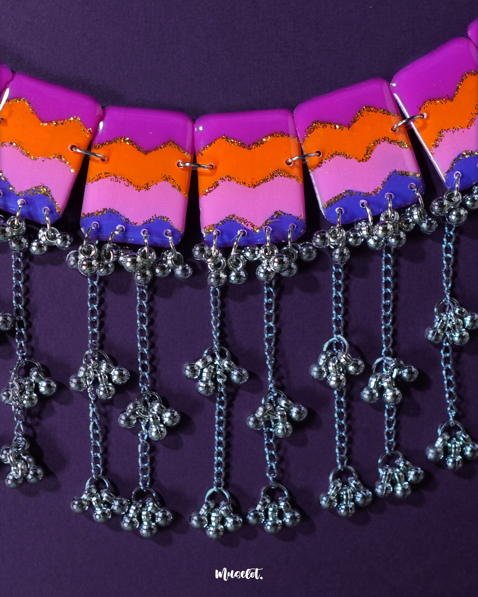 The Rangrezan handmade colorful necklace set is artfully displayed, showcasing its vivid palette of multicolored beads and traditional craftsmanship that brings a burst of festivity to any look — Muselot.