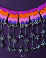 The Rangrezan handmade colorful necklace set is artfully displayed, showcasing its vivid palette of multicolored beads and traditional craftsmanship that brings a burst of festivity to any look — Muselot.
