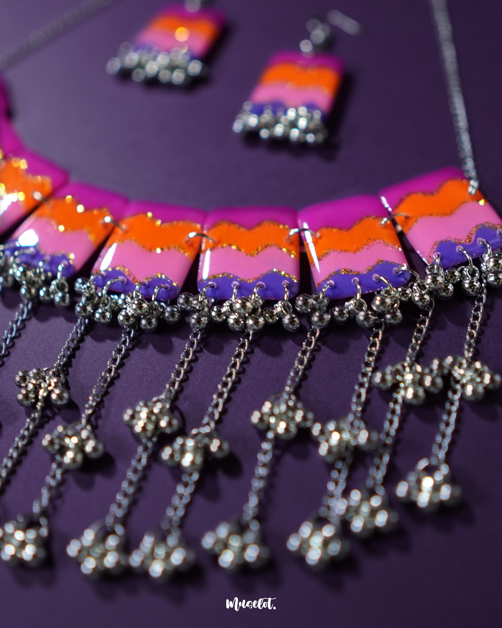 The Rangrezan handmade colorful necklace set is laid out to showcase its vibrant beads, shimmering metallic accents, and playful ghungroos — a boho statement piece that celebrates handcrafted charm — Muselot.