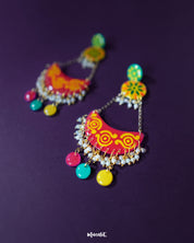 The vibrant Rangsiya chandbali earrings stand out with their bold fusion of colors and detailed motifs — accented with pearl danglers and antique-style metalwork that add depth and charm to every curve — Muselot.