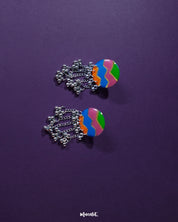Rangtarang colorful long chain earrings showcasing a vibrant fusion of hand-painted zigzag patterns in green, pink, blue, and orange, paired with dangling silver chains and metallic beads that dance with every movement, capturing the essence of playful elegance – Muselot.