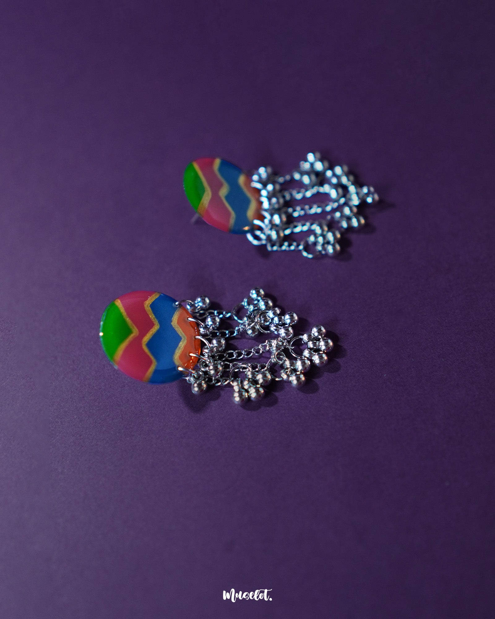A side view of the Rangtarang colorful long chain earrings showcasing their cascading layers of handcrafted beads and enamel work in vivid shades, capturing a joyful and bohemian spirit – Muselot.