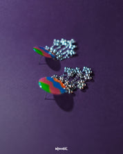The Rangtarang colorful long chain earrings displayed against a neutral backdrop, highlighting their fluid, dangling design and multicolored elements that add a playful yet elegant charm – Muselot.