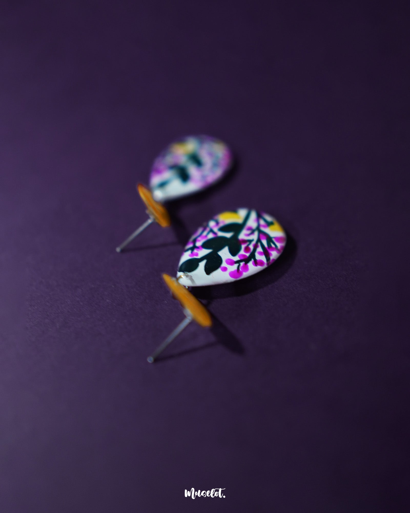 Raushanbahaar floral drop earrings in a teardrop shape, featuring delicate hand-painted blooms in pink and yellow with black detailing, highlighting festive charm and showcasing traditional craftsmanship with a modern twist — Muselot.