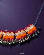 A zoom-in shot of the handmade traditional necklace set against a rich purple background, showcasing the vibrant beadwork, delicate patterns, and expert craftsmanship — Muselot.