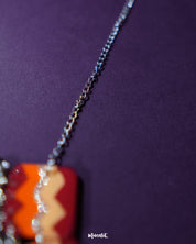 A close-up focusing on the intricate chain of the handmade traditional necklace set, highlighting its detailed links and fine craftsmanship against a subtle background — Muselot.
