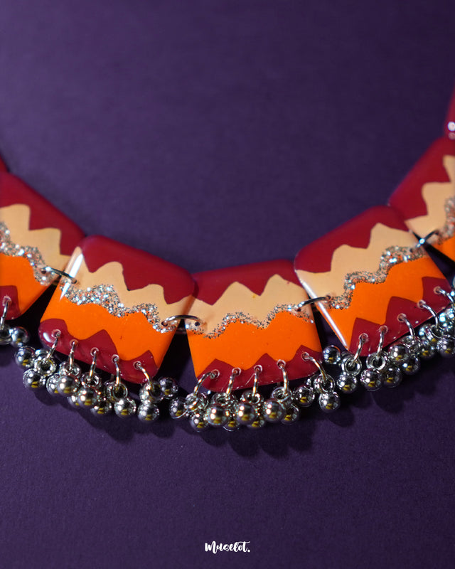 A close-up shot of the Sehrish handmade traditional necklace set laid out on a soft surface, highlighting the pendant’s intricate detailing and antique finish, paired with delicate matching earrings — Muselot.