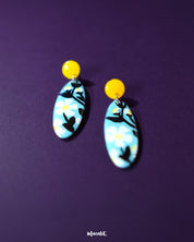 Shaamgul drop earrings displayed on a soft background, showcasing their handcrafted floral design with muted tones and intricate beadwork that reflects traditional charm — Muselot.