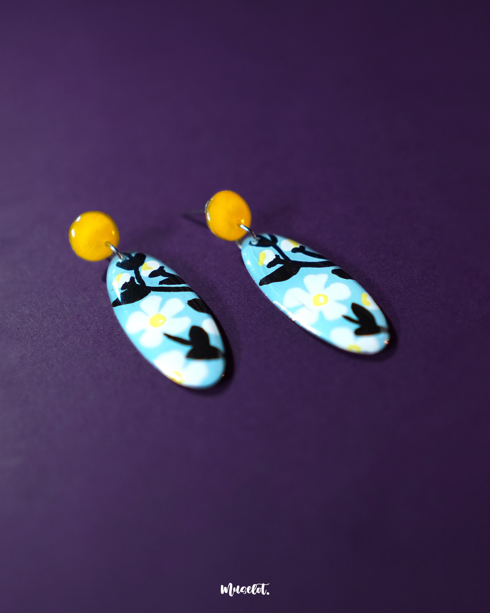 Shaamgul drop earrings captured from a side angle, highlighting their detailed petal structure and dangling beads that lend a graceful, bohemian appeal — Muselot.