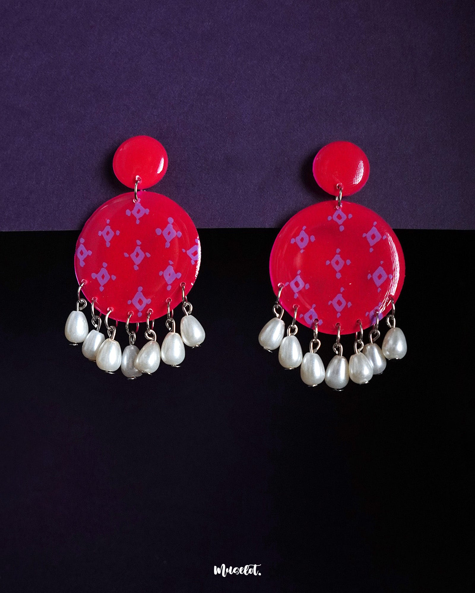 Shabnam pink pearl drop earrings featuring round hot pink studs with soft lilac geometric motifs and dangling white pearl beads, showcasing vibrant femininity and highlighting graceful movement — Muselot.
