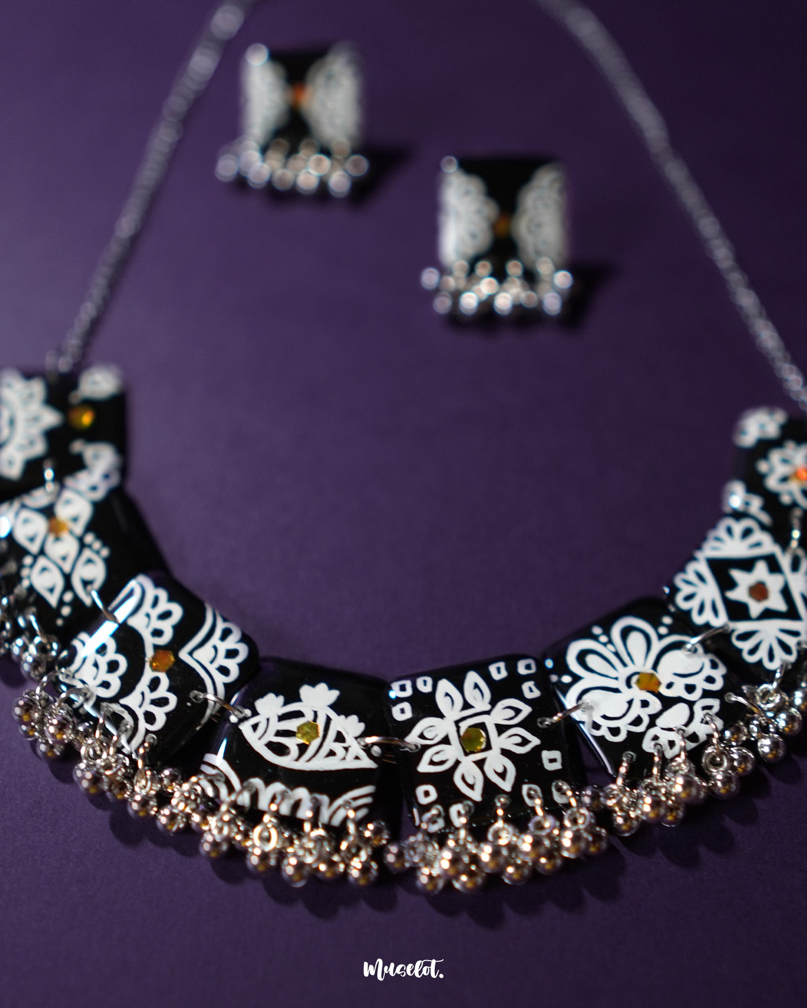 A close-up view of the Shabnoor black floral jewelry set, showcasing the intricate floral patterns and the rich black finish that exudes elegance and traditional charm — Muselot.