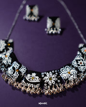 A close-up view of the Shabnoor black floral jewelry set, showcasing the intricate floral patterns and the rich black finish that exudes elegance and traditional charm — Muselot.