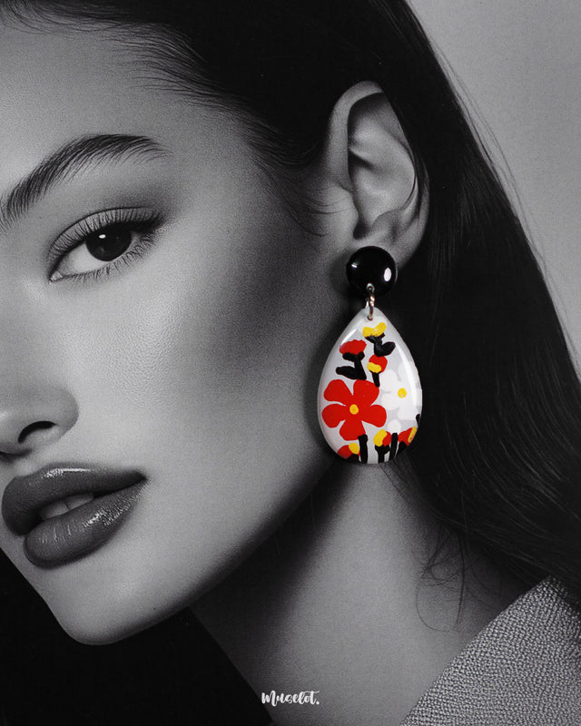 A close-up shot of the model wearing the Shafaq drop earrings, highlighting the intricate craftsmanship and the way the delicate drops frame the face with subtle elegance — Muselot.