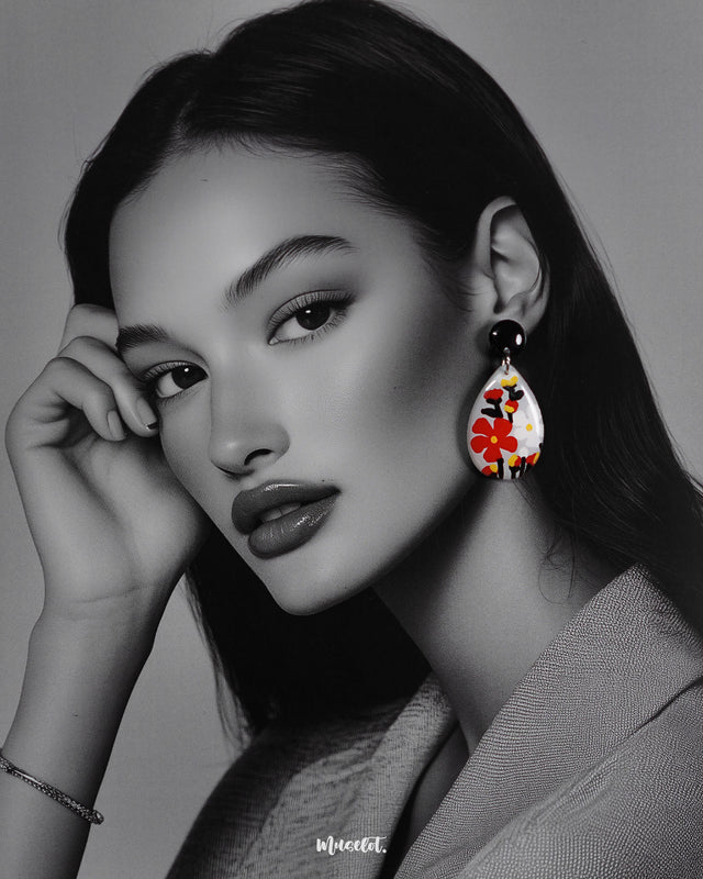A model wears the Shafaq drop earrings, showcasing their elegant handcrafted detailing and fluid design that adds a graceful charm to her look — Muselot