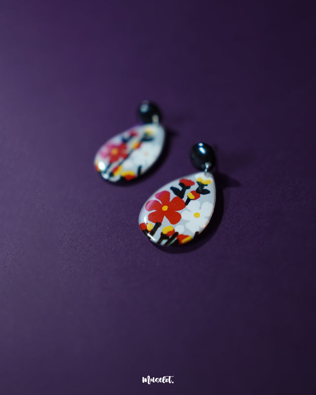 A close-up of the Shafaq floral earrings highlighting the intricate handcrafted petals and vibrant hues, designed to bring a graceful blend of elegance and tradition to any look — Muselot.