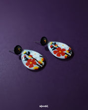 A front-facing shot of the Shafaq floral earrings displaying their symmetrical design and radiant floral accents, reflecting timeless charm and everyday elegance — Muselot