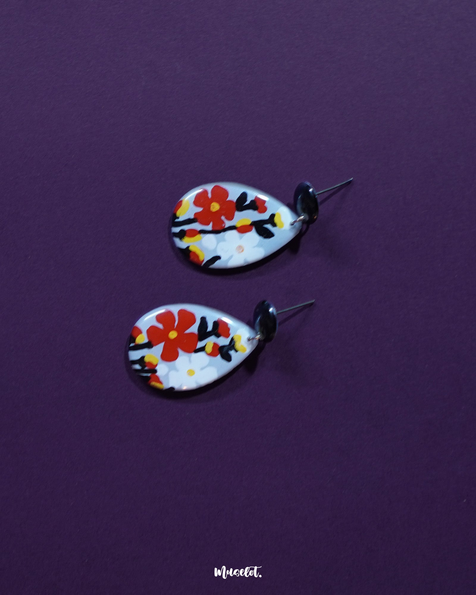 A Shafaq floral earrings laid against a soft background, showcasing their delicate petal details and handcrafted finish that adds a refined, graceful touch — Muselot.