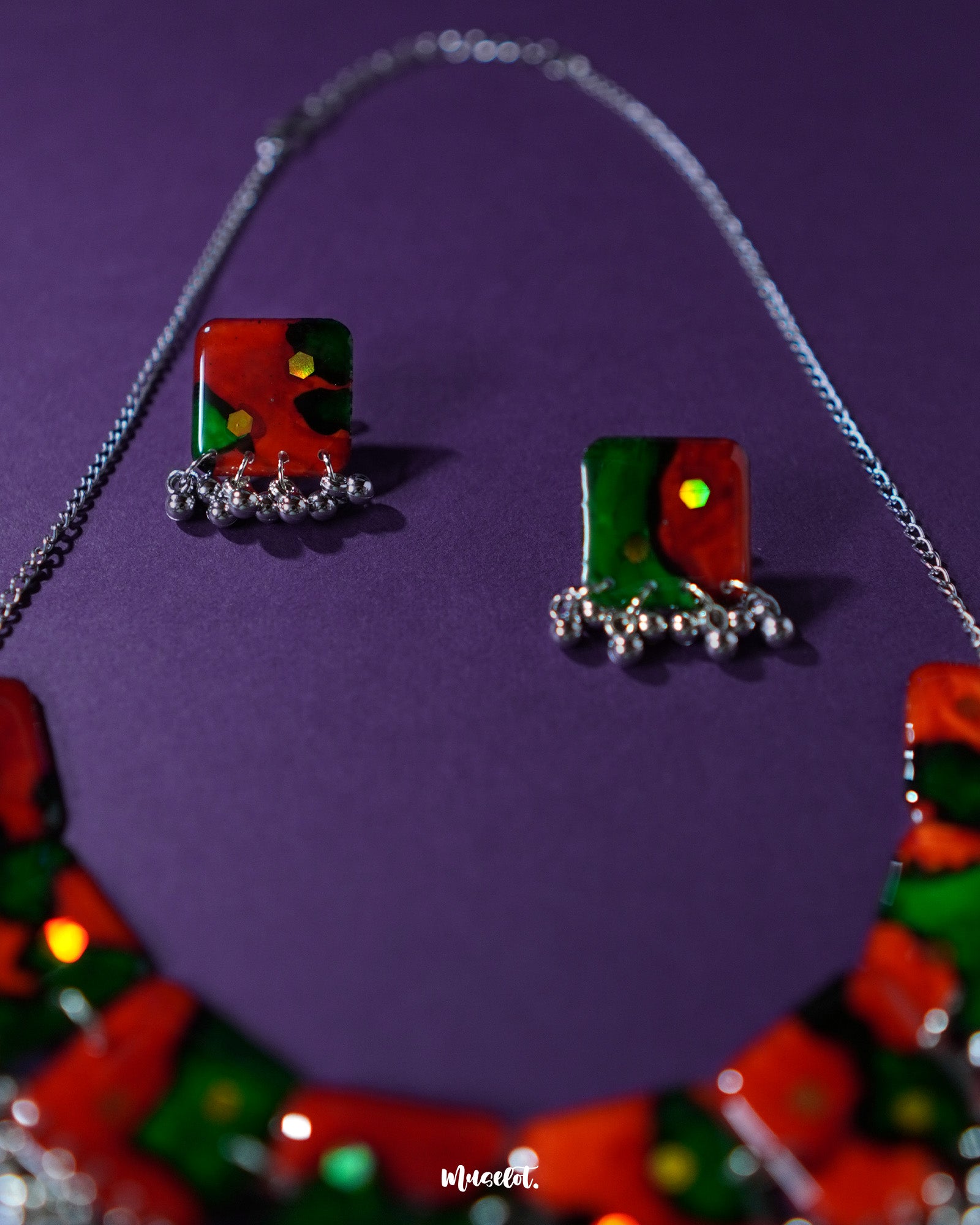 Close-up of the Surkhbaagh handmade earring showcasing oxidized silver detailing, mirror accents, and deep maroon beadwork that reflect ethnic charm with a bold, artisanal edge — Muselot.