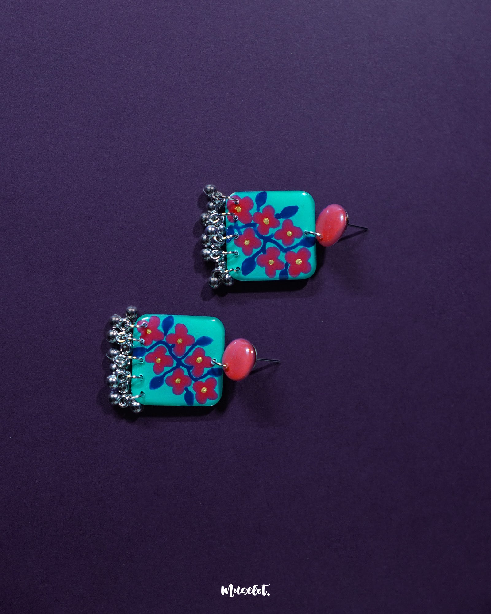 Surkhili floral earring highlighting the intricate red petals and fine silver accents, showcasing its detailed craftsmanship and traditional elegance — Muselot.