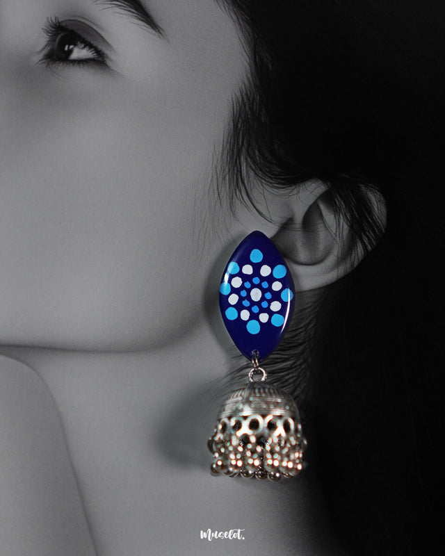 A woman wearing trendy lightweight jhumkas with intricate oxidized silver domes and marquise-shaped blue tops, highlighting the perfect blend of comfort and contemporary ethnic charm — Muselot.