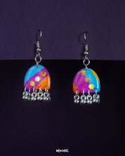 Ufaq multicolor hook earrings elegantly drape against a deep, neutral background, with vibrant hues and patterns that exude a playful yet refined charm — Muselot.