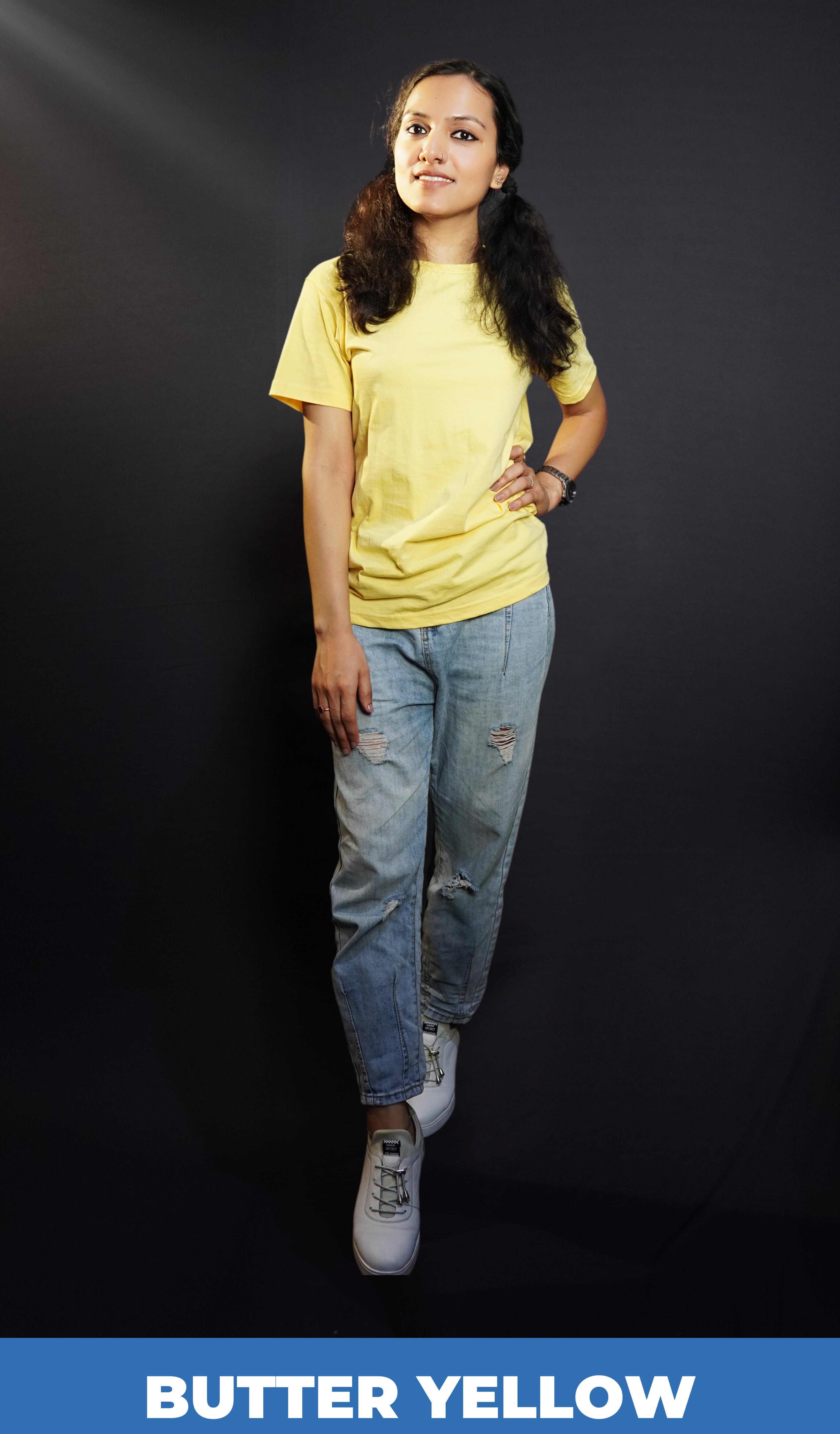A classy model posing confidently as she places a hand on her waist and the other gently on her thigh, wearing a short sleeved plus size moisture wicking butter yellow t-shirt, highlighting a trendy everyday look-Muselot