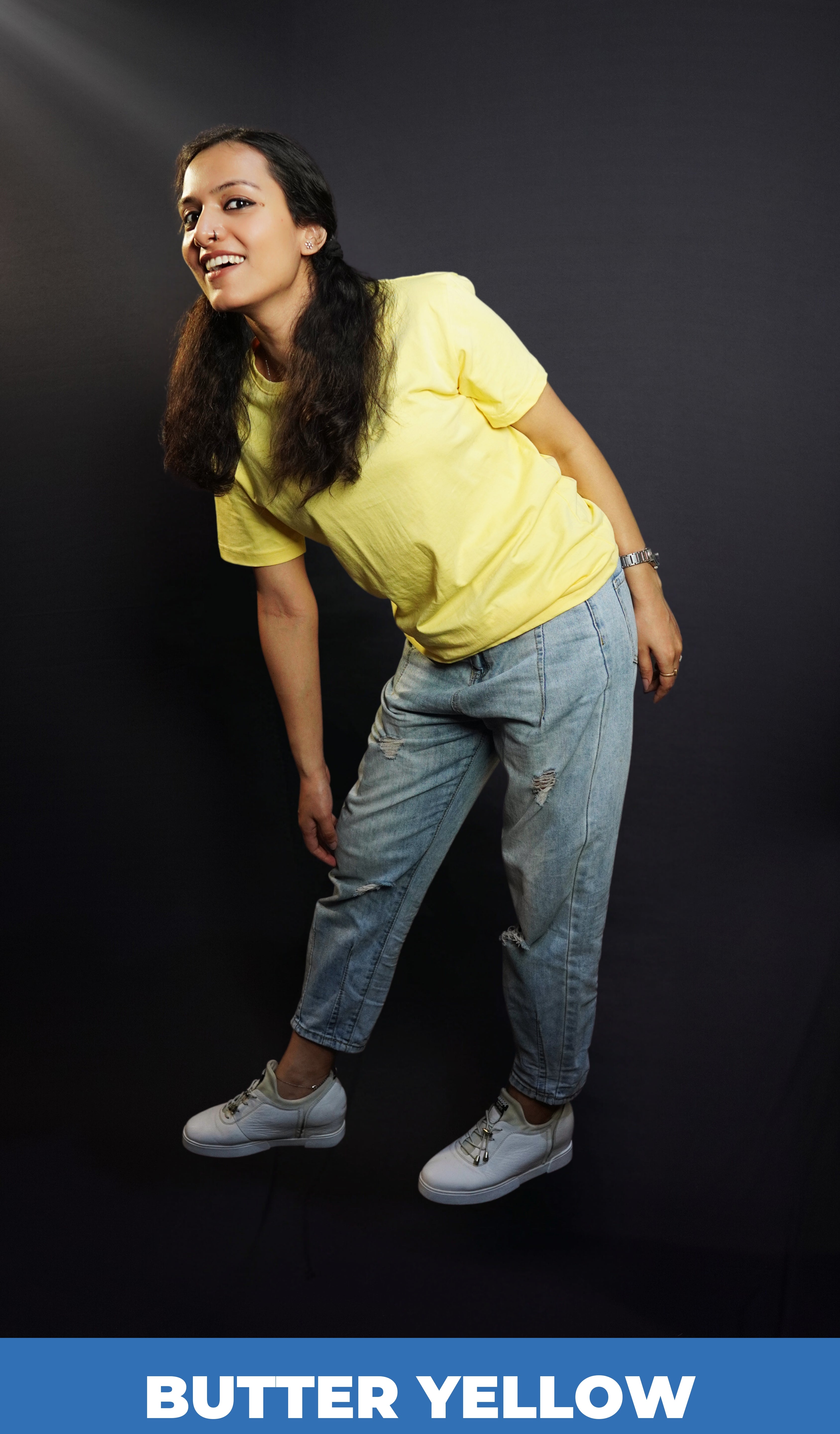 A woman posing happily as she stands sideways bending forward, wearing adult's quich drying round neck short sleeved t-shirt, highlighting a popular snug fit-Muselot