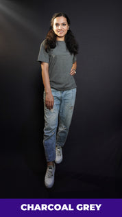 a stylish model posing confidently in round neck stretchable plain t shirt looking directly at the camera with a smile on her face-muselot