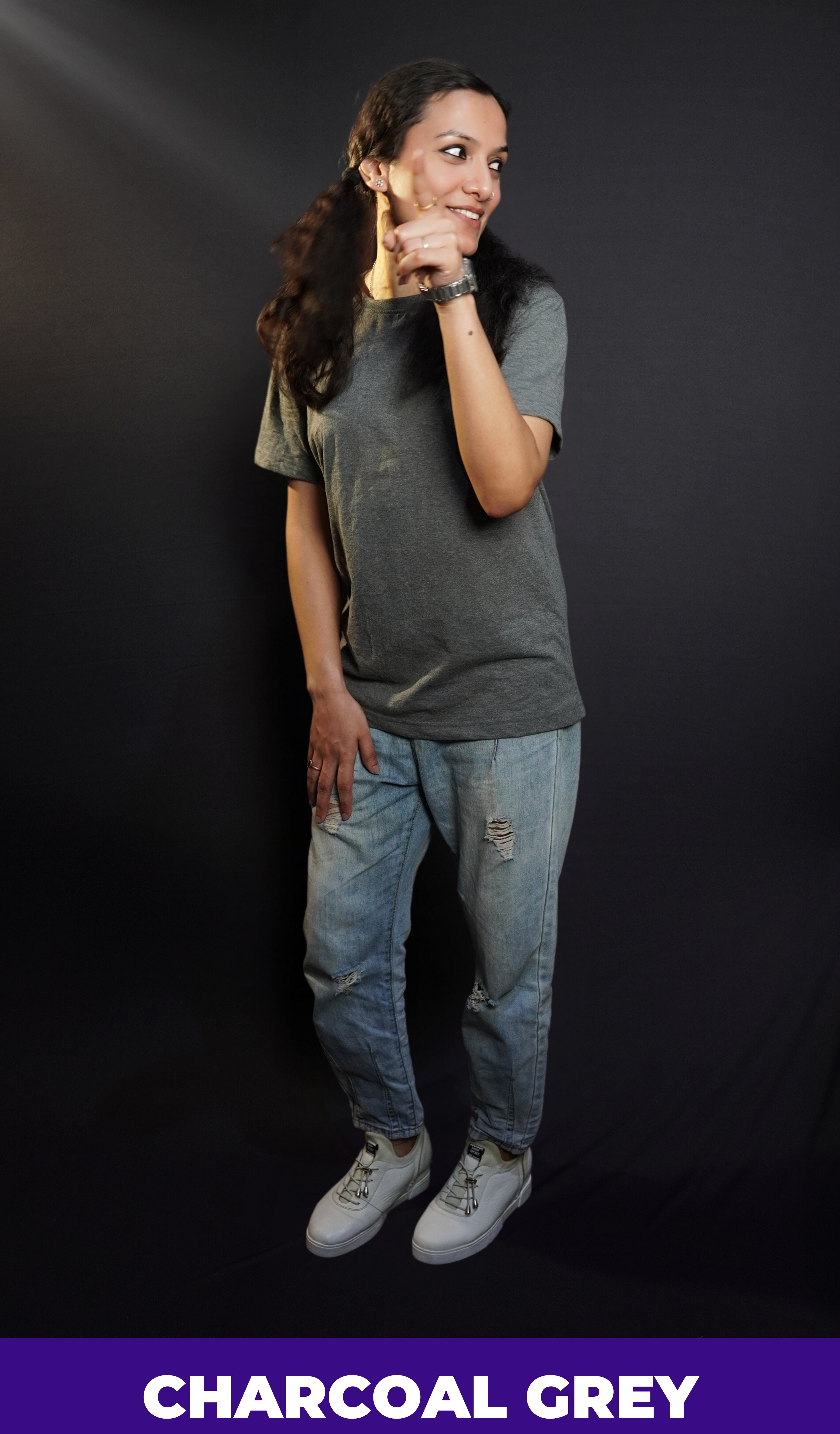 a pretty girl having fun with herself wearing an elegant looking charcoal grey short sleeved t shirt on ripped jeans-muselot