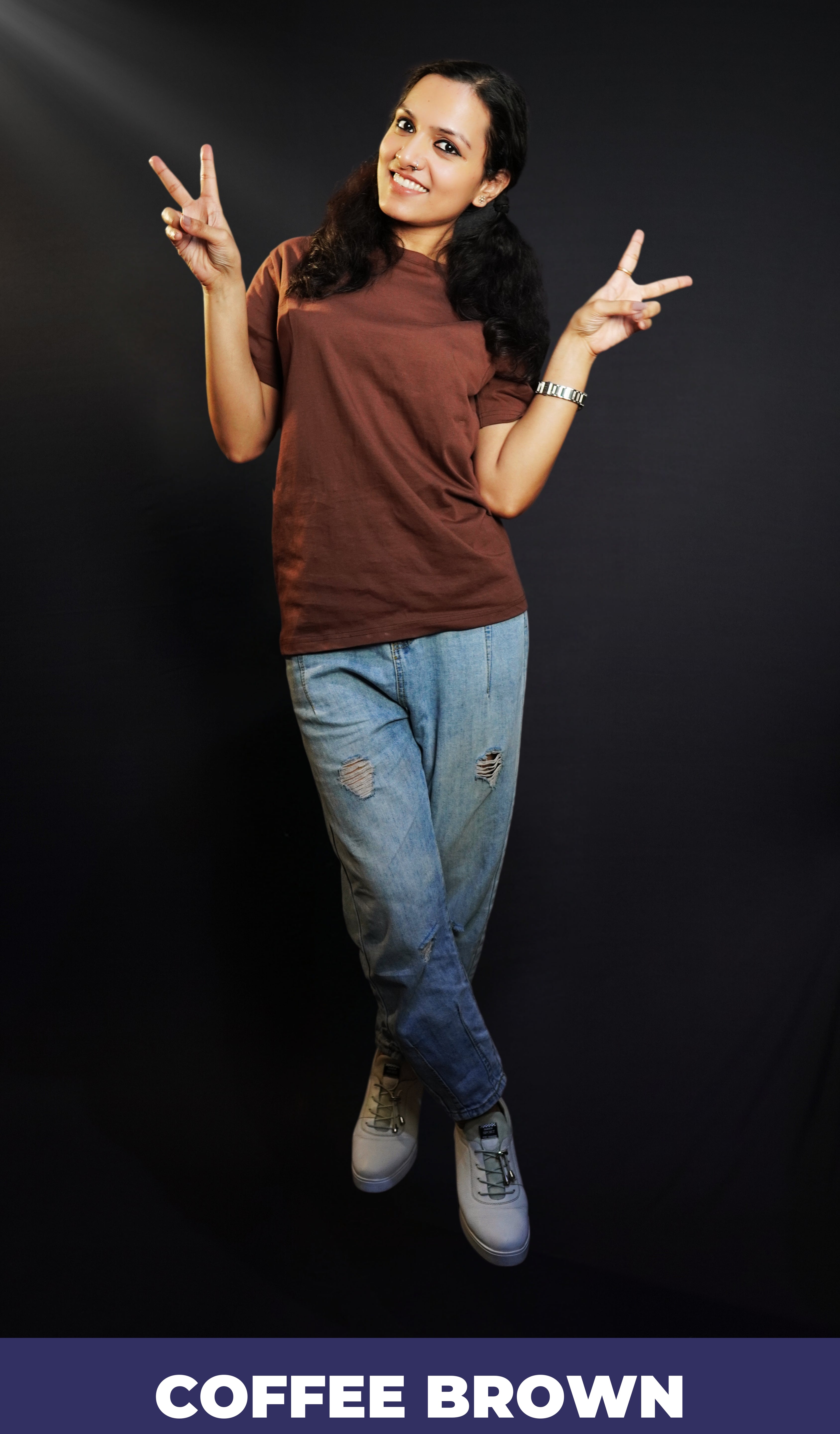 A woman happily posing by making a v sign with her fingers, wearing a plain adults round neck coffee brown t-shirt, showcasing a relaxed snug fit-Muselot