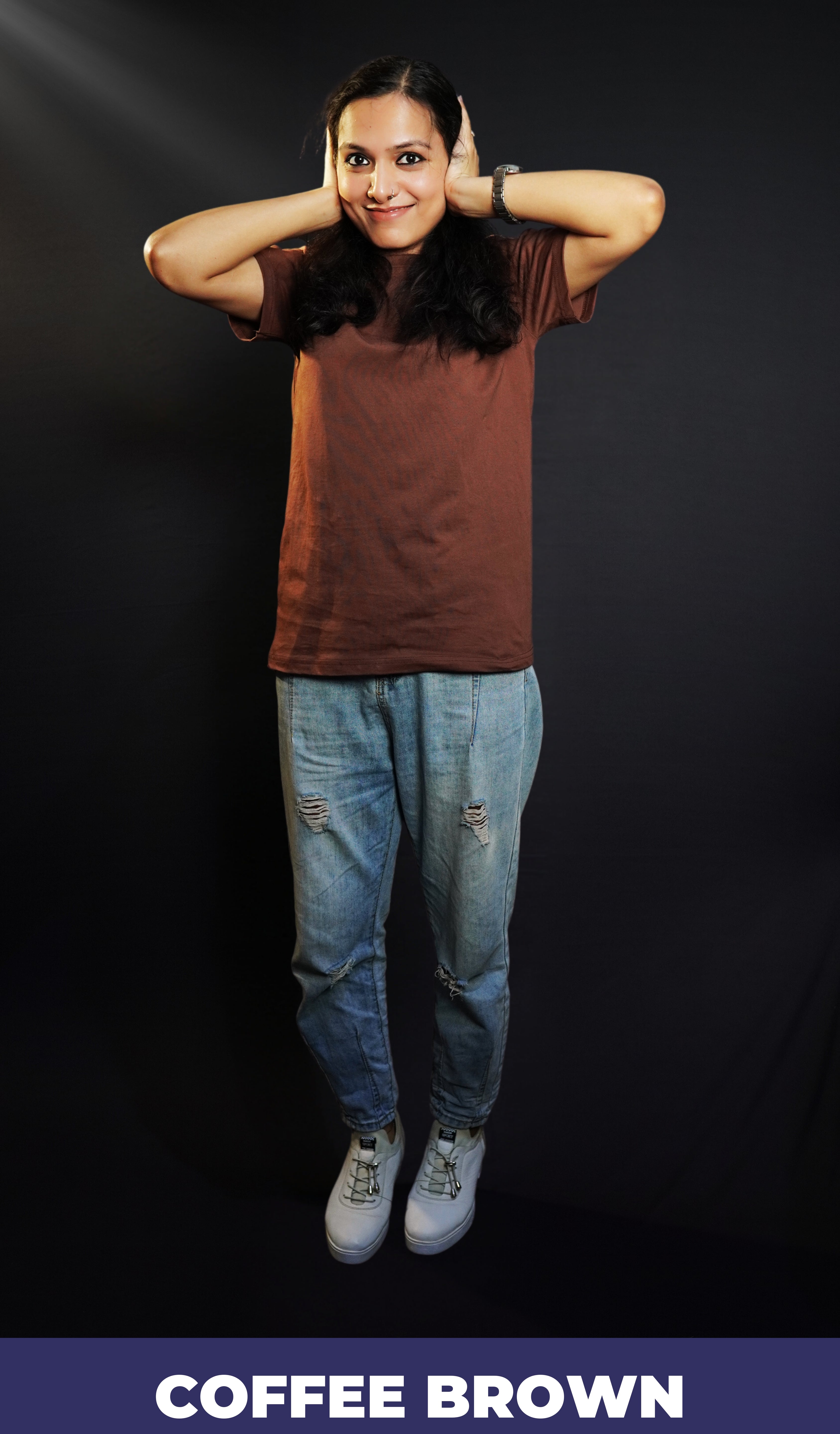 A woman wearing a coffee brown plain stretchable short sleeved t-shirt, posing with her hands on her ears, showcasing a roomy comfortable fit-Muselot