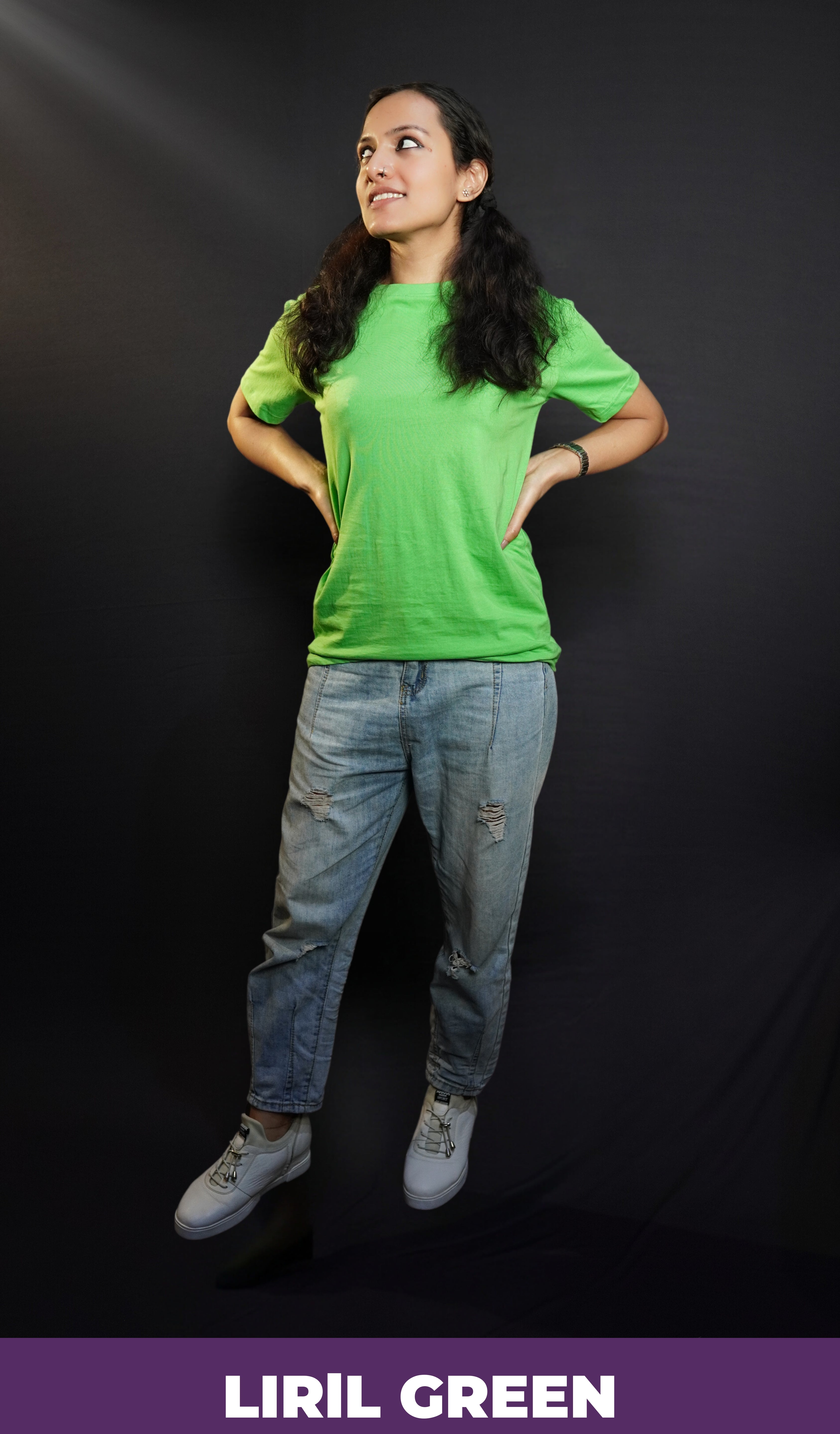 A stylish model posing with her hands on her sides looking sideways, wearing a lime green cotton long length adult's t-shirt, highlighting a trendy snug fit-Muselot