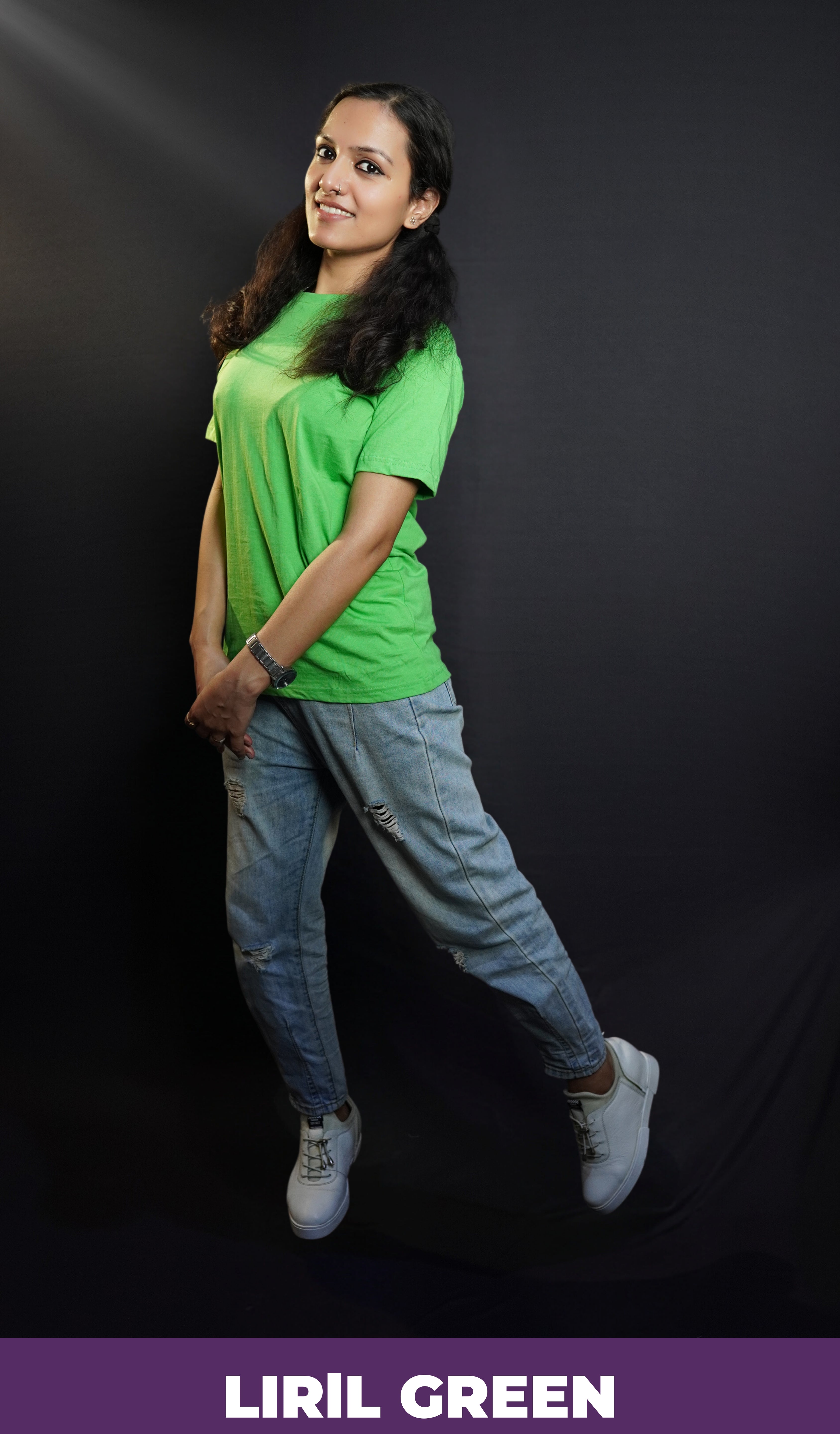 A smiling woman wearing a plus size lime green plain t-shirt with short sleeves and round neck, standing sideways as she sways slightly with her hands grabbing each other, showcasing a fashionable baggy fit-Muselot