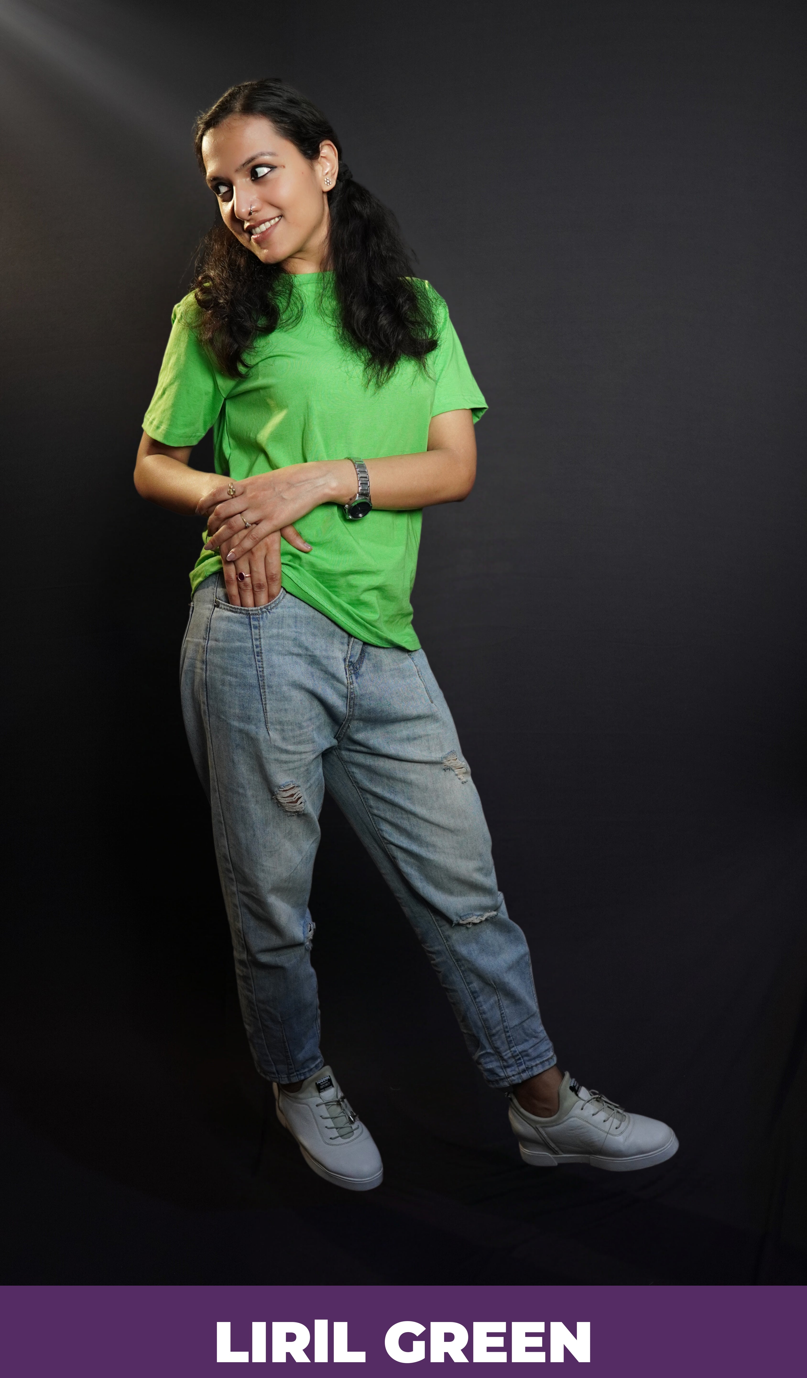 A stylish model posing happily with her hand about to go into the pocket of her jeans and another lying gently upon it, looking sideways, wearing a plain summer round neck moisture wicking lime green t-shirt, highlighting a voguish cozy look-Muselot