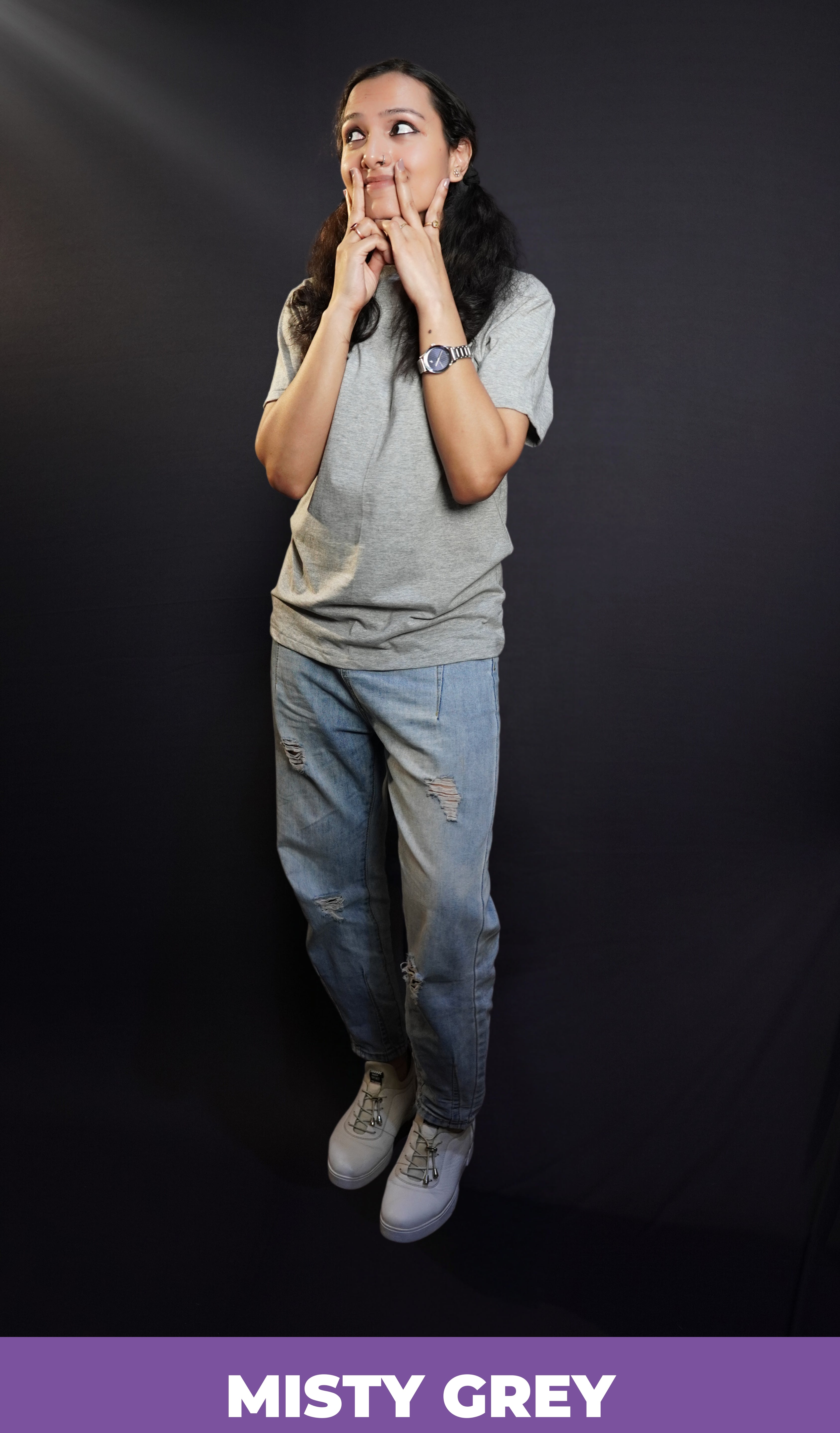 A woman wearing a long length round neck short sleeved plain t-shirt, posing with her hand on her cheeks making a v with her fingers, showcasing a soft homey fit-Muselot